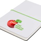 A white notebook with a green elastic band around it. The cover features an image of a red apple with a leaf and the text THE HEALTH GROUP in green letters.