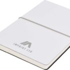 A closed white notebook with Imprint Ltd printed on the cover. It has a slim gray elastic band around it and a ribbon bookmark visible at the edge.