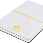 A white notebook with a yellow elastic band and a bookmark ribbon. The cover features a yellow embossed logo and text that reads IMPRINT LTD. The notebook is angled slightly on a plain white background.