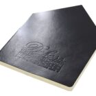 A black notebook with an embossed logo reading Deboss, The Premium Option on the cover. The notebook is closed, showing its sleek and simple design.