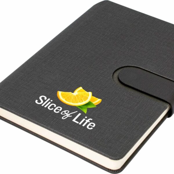 A black notebook with a textured cover and a closure strap. The cover features an illustration of a sliced orange and the text Slice of Life in white. A ribbon bookmark is visible.