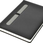 A closed black hardcover journal with a perforated texture and a rectangular transparent window on the cover. It has white pages and a black ribbon bookmark.