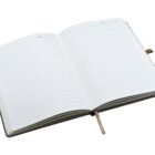 An open notebook with lined pages and a brown ribbon bookmark, showing space to write dates at the top of each page.