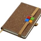 A brown speckled notebook with an elastic strap, featuring a colorful square logo near the strap. The notebook is closed and appears to have a bookmark ribbon.