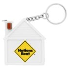 Keychain shaped like a white house with a chimney, featuring a yellow diamond-shaped Nations Rent logo on the front. A metal ring is attached by a short chain.
