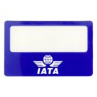 Blue luggage tag with a clear window for an insert. Features white text and design, including a globe with wings and the letters IATA below it.