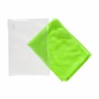 A bright green towel partially folded next to a clear, empty plastic pouch against a plain white background.