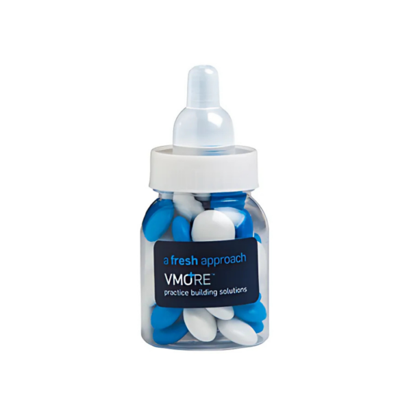 The Logo Printed Bottle With Choc Beans is a clear baby bottle labeled a fresh approach and VMORE practice building solutions, filled with blue and white capsule-shaped objects, topped with a white cap and translucent nipple.