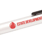 A black and silver ballpoint pen featuring a clip and stylus tip. The pen is branded with the text ESTATE DEVELOPMENT CO. in red letters alongside a red logo.