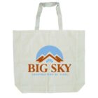 A beige tote bag with two handles featuring a logo. The logo includes a stylized mountain, a blue half-circle, and the text BIG SKY Construction Services in bold letters.