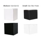 Four boxes are shown. The medium-sized boxes, one white and one black, measure 12x12x12 cm. The small-sized boxes, one black and one white, measure 12x10x11 cm. Labels indicate their sizes and dimensions.