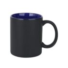 A matte black ceramic mug with a glossy blue interior. It has a large handle, and its positioned at an angle, showing both the handle and the cups opening. The mug is set against a white background.