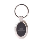 A silver metal keychain with an oval-shaped black center featuring the word Mississauga and a geometric design above it. The keychain has a round keyring at the top.