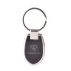 A silver metal keyring with a black oval pendant engraved with the word elepheart.com and a heart-shaped elephant logo.
