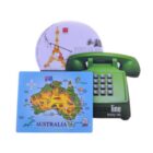 Three colorful mousepads are displayed: one features a green retro telephone design, another has an artistic Eiffel Tower illustration with Vive la Vie text, and the third shows a map of Australia with landmarks.