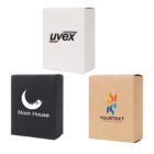 Three product boxes with different designs: a white box with uvex text, a black box with Moon House and a crescent moon logo, and a brown box with a colorful flame logo and placeholder text YOURTEXT.