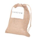 A burlap drawstring bag with the word RANDOM printed on a white label attached to the front.