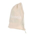 A beige drawstring bag with the name Victoria printed in white on the front. The bag is slightly wrinkled and tied at the top.