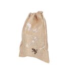 A burlap drawstring bag with a floral and bird design on the front. The background is white.