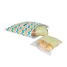Chevron-patterned zippered pouch with orange, white, and teal colors, containing packaged buns. A packaged bun is partially out of the pouch, with green and beige wrapper.