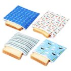 Colorful reusable sandwich bags with various patterns—anchors, London buses, stripes, and clouds. Each bag holds a slice of bread, partially visible, against a plain white background.