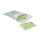 A colorful, zigzag-patterned pouch partially opened to reveal green packaged sanitary pads. One pad is placed outside the pouch.