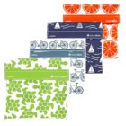 Four reusable snack bags are displayed, each with a unique design: orange slices, sailboats, bicycles, and turtles. They have a white flap for labeling with a name.