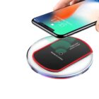 A smartphone is being placed on a round, black wireless charger with a red accent and the label Fantasy Wireless Charger. The phone screen displays a bright, colorful wallpaper and the time, 4:17.