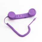 A purple retro-style telephone handset with a curly cord and a modern connector plug, placed on a white background.