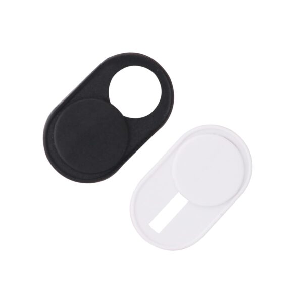 Two webcam covers are shown side by side. One is black, and the other is white. Each cover features a sliding mechanism to reveal or conceal the webcam lens. The design is oval-shaped with a circular opening for the lens.