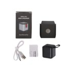 Wireless mini speaker product package. Includes a black speaker with a loop handle, a USB charging cable, a user manual, and a black box featuring an image of the speaker on the front with the text Sound Beyond Size.