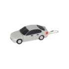 A small toy car designed like a gray sedan, featuring black windows and wheels, attached to a keychain.
