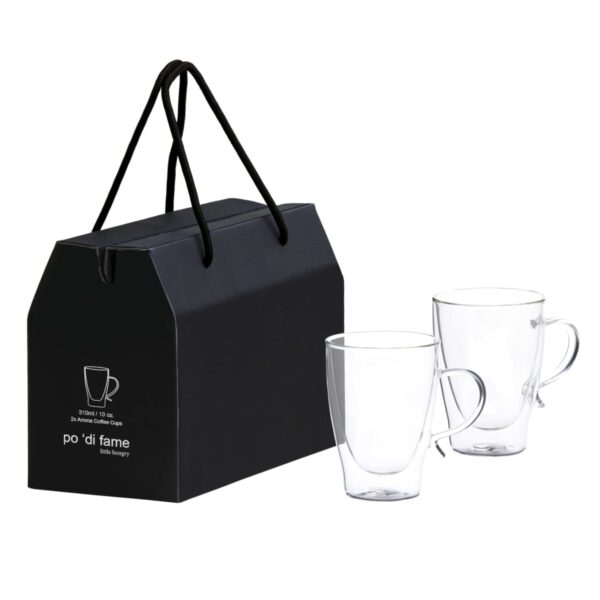 A black cardboard box with a handle, featuring an outline of a mug and text. Two transparent glass mugs with handles are placed beside the box.