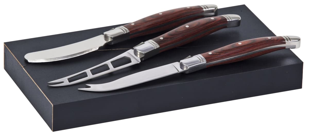 Three cheese knives with wooden handles on a black rectangular box. The knives include a spreader, cleaver, and fork-tipped knife, each with a shiny stainless steel blade.