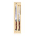 A carving knife and fork set with polished wooden handles in a wooden box. The knife has a long, narrow blade, and the fork has two sharp tines. Both have decorative metal accents at the handles.