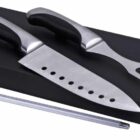 A set of kitchen tools includes a large knife with holes in the blade, a two-pronged fork, and a honing rod. The utensils have black handles and are displayed on a black rectangular block.