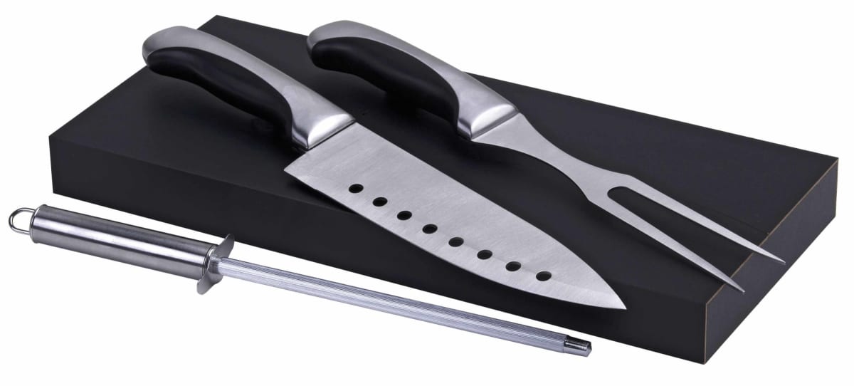A set of kitchen tools includes a large knife with holes in the blade, a two-pronged fork, and a honing rod. The utensils have black handles and are displayed on a black rectangular block.