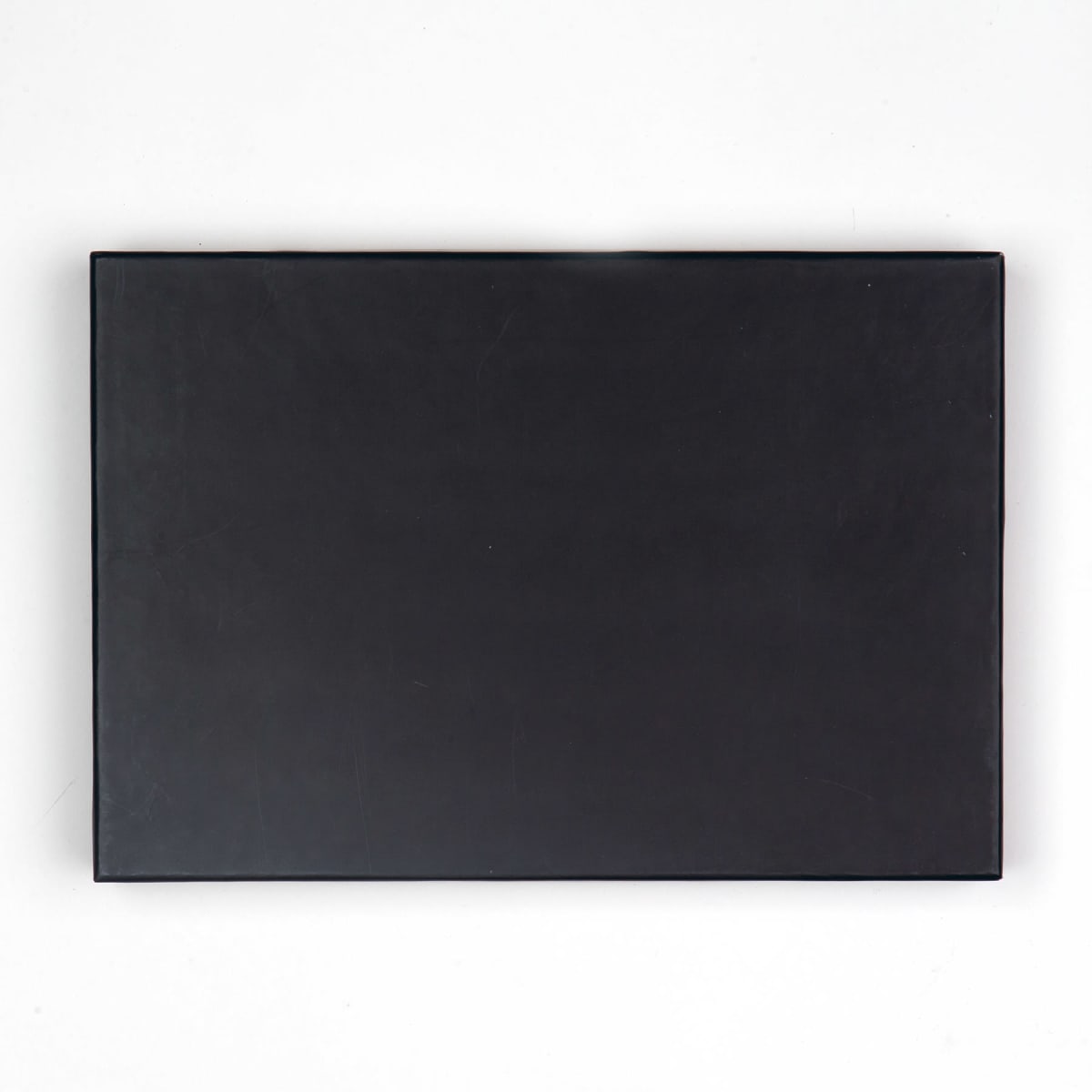 A closed, plain black rectangular box against a white background.