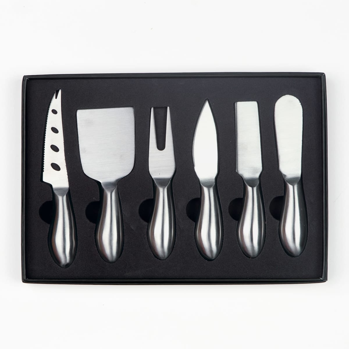 A set of six stainless steel cheese knives displayed in a black foam casing. The knives include a perforated knife, flat chisel, fork-tipped knife, narrow blade, flat blade, and a spreader.