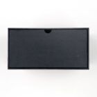 A closed, rectangular black shoebox with a subtle notch at the top sits against a plain white background.