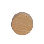 A round wooden lid with a smooth surface, displaying natural wood grain patterns. The lid is positioned vertically against a plain white background.