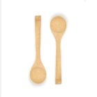 Two wooden spoons with smooth, round bowls and long handles are placed side by side on a plain white background.