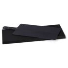 Two black rectangular cutting boards are stacked, one slightly angled on top of the other. The top board has a handle with gold-colored rivets. The boards are set against a white background.