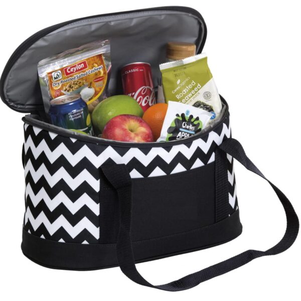 A black and white zigzag-patterned insulated lunch bag is open to reveal various snacks, including a can of Coca-Cola, a small bottle, an apple, a pack of cashews, a bag of roasted seeds, and a snack pack of velvety smoothies.