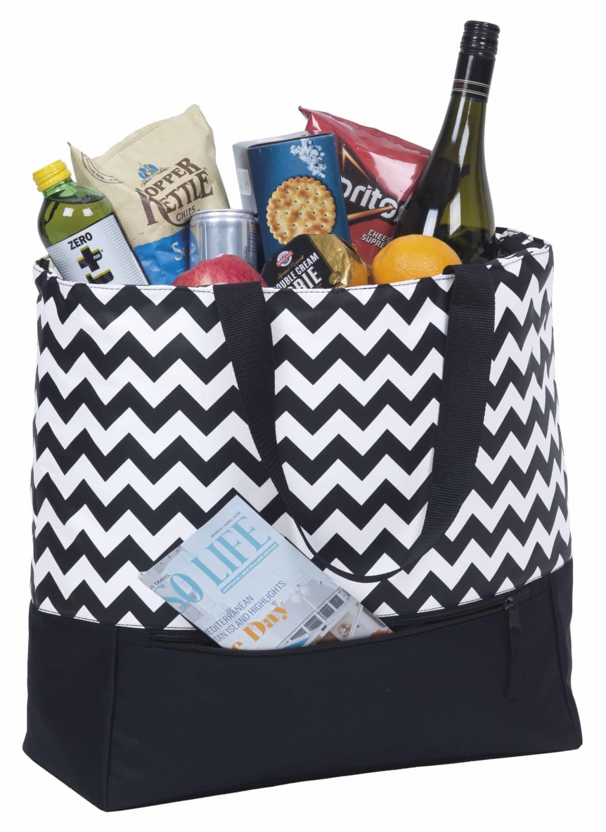 A black and white zigzag patterned tote bag filled with various groceries, including a wine bottle, chips, crackers, apples, and a lemon. A magazine is tucked into a front pocket of the bag.