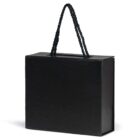 A black box with textured sides and a twisted black rope handle on top. The box is rectangular in shape and sits on a white background, casting a slight shadow beneath.