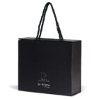 A black rectangular bag with twisted rope handles. The front features a small illustration of an espresso cup and the text 110ml / 3.7oz and po di fame little luxury.