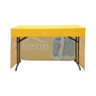 A table with a yellow cover displaying the word SATCHILL and outdoor line art. The table has a clear panel showing camping gear, including a backpack and rope.