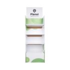 Empty white retail display stand with three shelves and a lower storage area. The design features green circular patterns and a header displaying Plano with a logo.