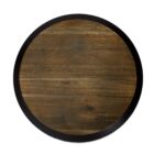A round wooden wall art piece with a black outer rim and natural wood grain center, showcasing various shades of brown. The surface is smooth and polished, highlighting the woods natural texture.